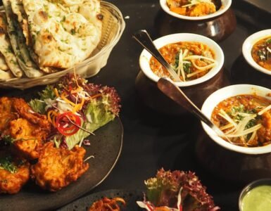 A mouth-watering display of Indian cuisine featuring naan, curry, and pakoras perfect for a delightful meal.