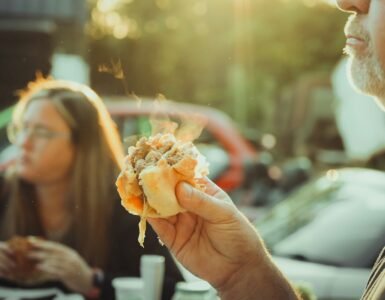 a man holding a hot dog in his hand