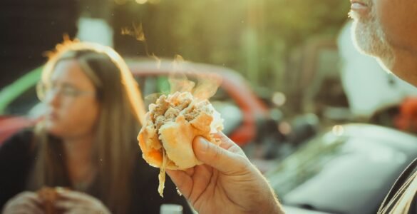 a man holding a hot dog in his hand